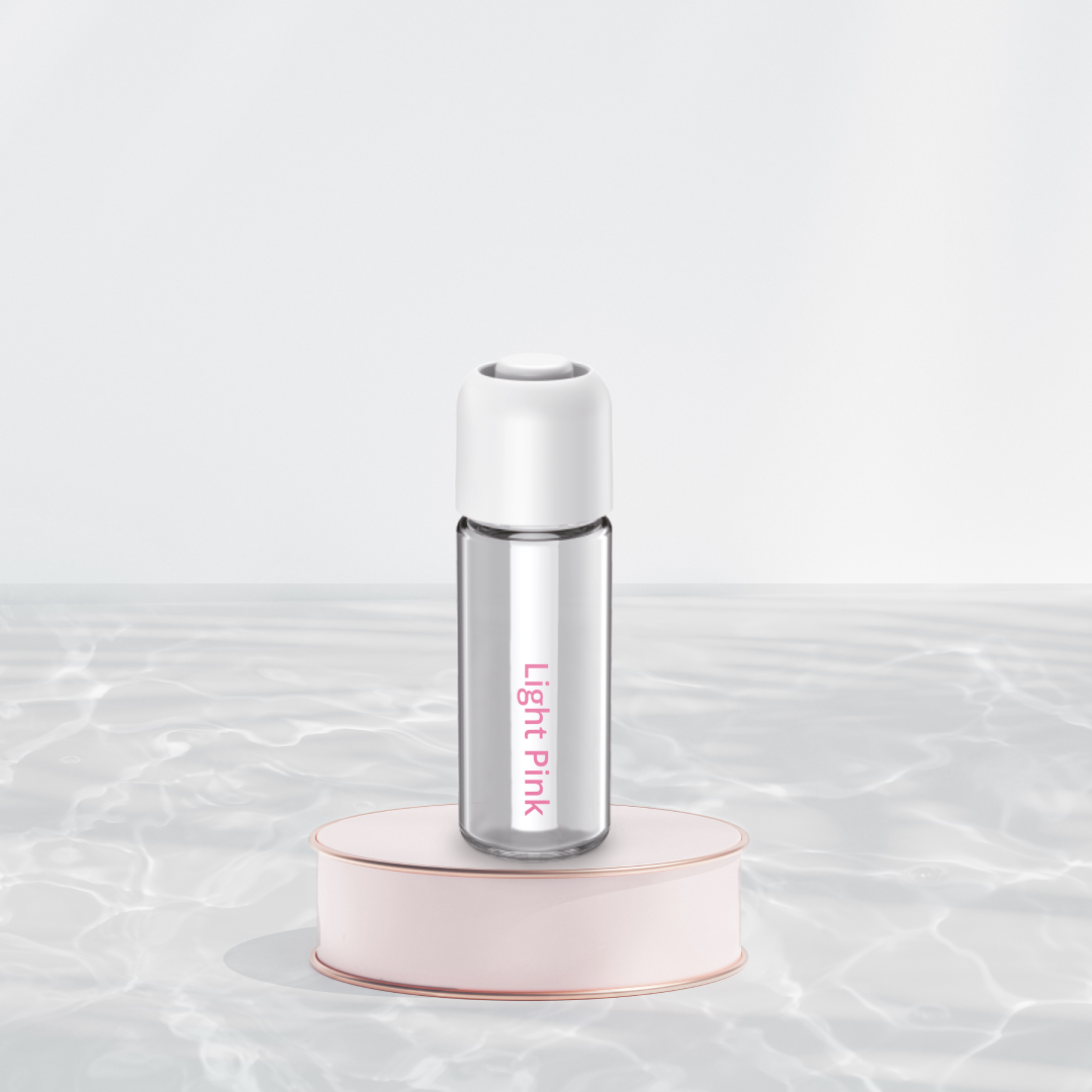 Light Pink refill fragrance bottle for Capsule 33 on a pink stand